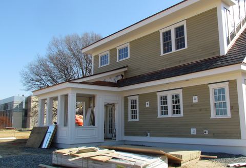 New two-story house with fiber cement lap siding and white trim nearly finished