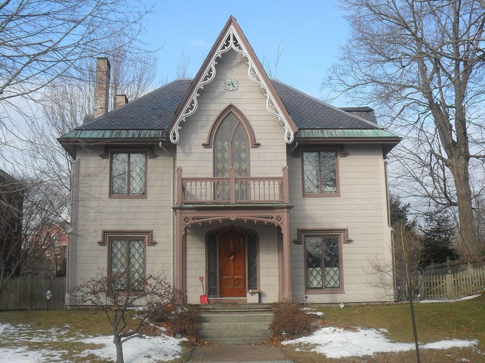 Gothic-style house with carved bargeboard trim, a pointed window and diamond-pane sashes